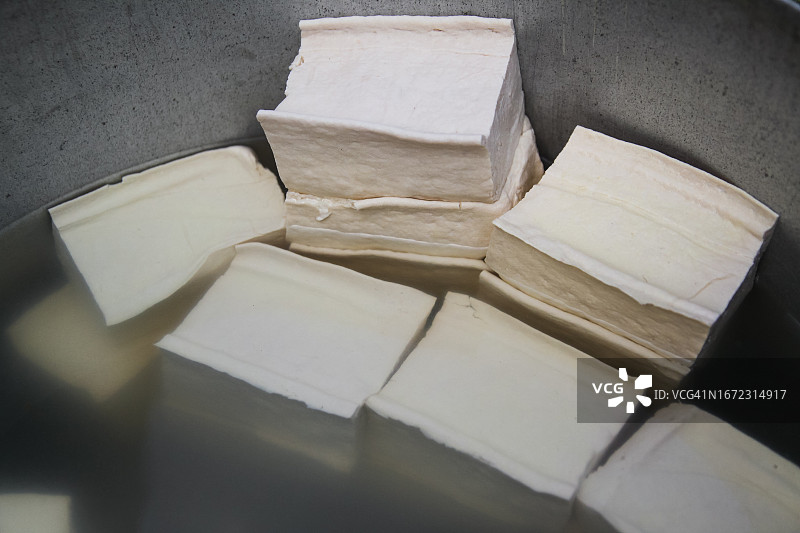 新鲜豆腐在铝碗中晾晒图片素材