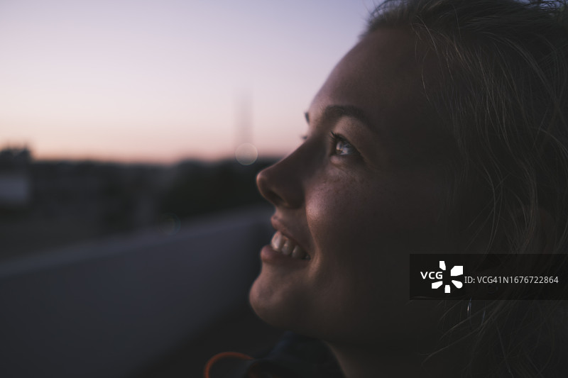 面带微笑、仰望天空的白人女孩特写图片素材