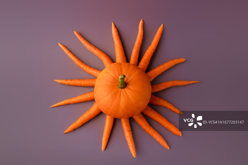 紫色背景上的胡萝卜南瓜太阳造型图片素材