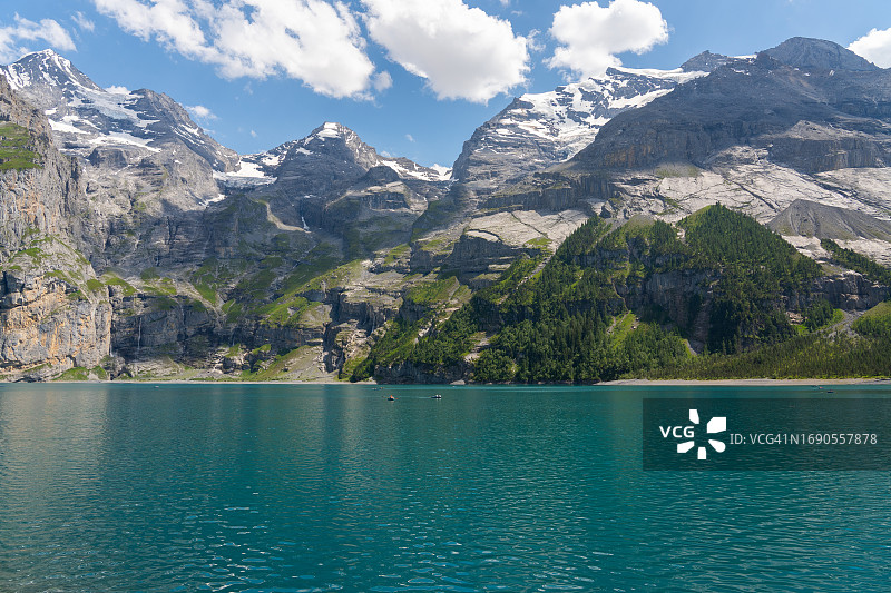 瑞士阿尔卑斯山脉碧绿的Oeschinnensee湖及瀑布图片素材