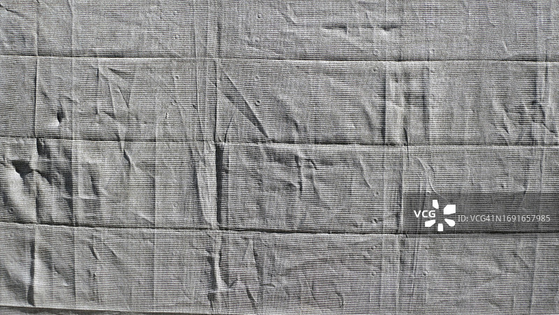 瑞士洛桑建筑工地围栏上灰色纹理防水布的特写图片素材