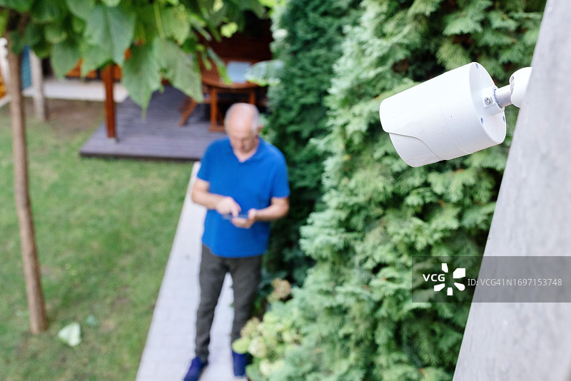 年长的男人安装家庭监控摄像头图片素材