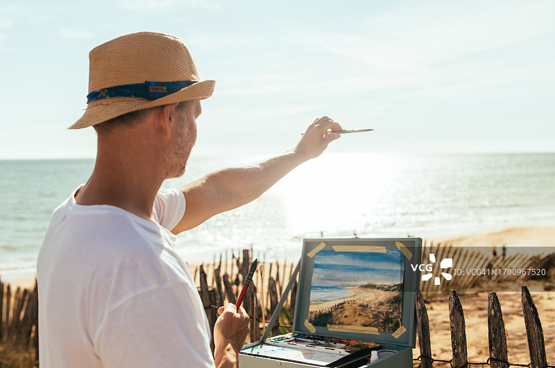 艺术家在海滩上画水彩画图片素材