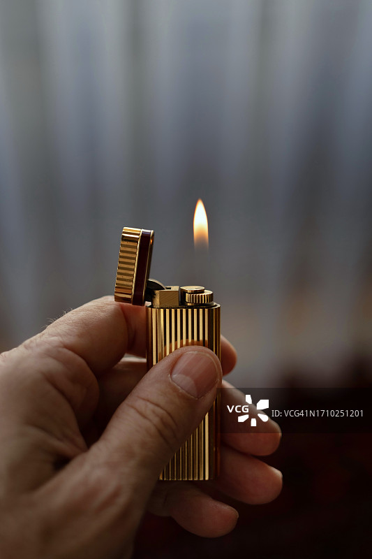 拿着打火机的左手特写图片素材