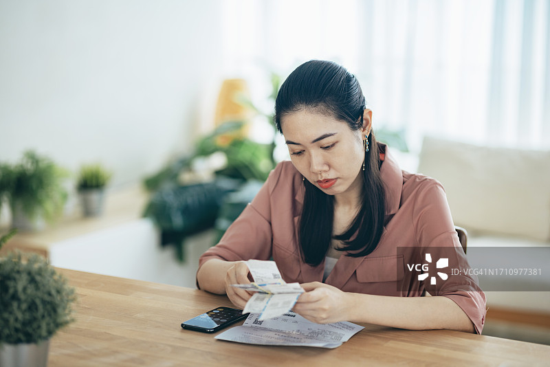 在家查看购物收据的亚洲女性图片素材