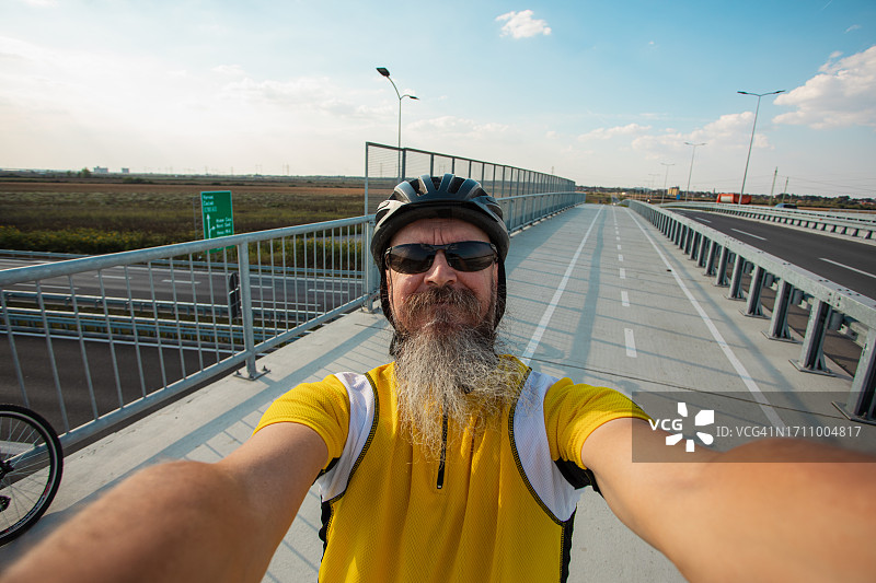骑行道上的50岁自行车骑行者自拍图片素材