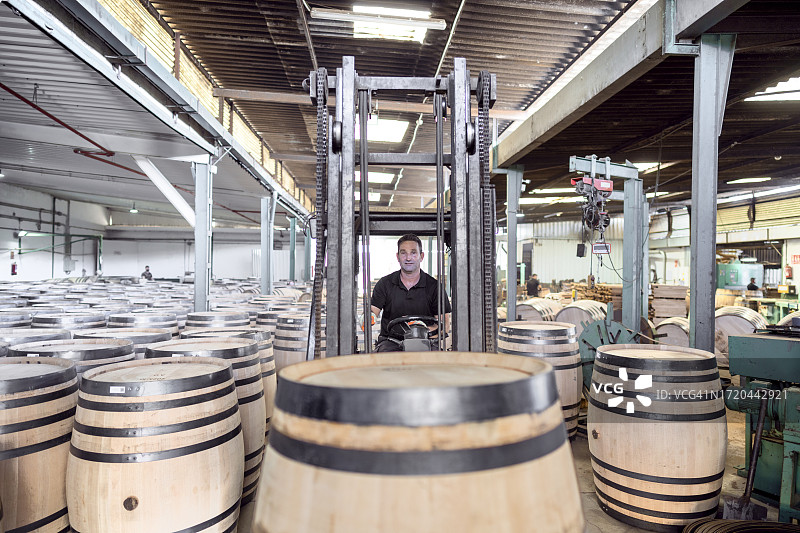 赫雷斯桶匠工坊的工人用机器将新制成的桶装上卡车，运送给苏格兰的麦芽威士忌生产客户图片素材