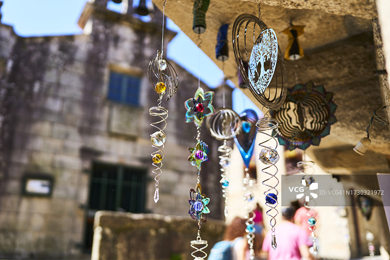 房子外屋顶上悬挂的风铃的侧面仰视照片图片素材