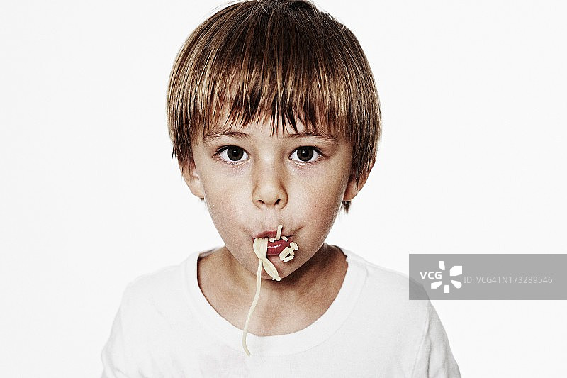 吃意大利面的男孩（6-7岁）肖像图片素材