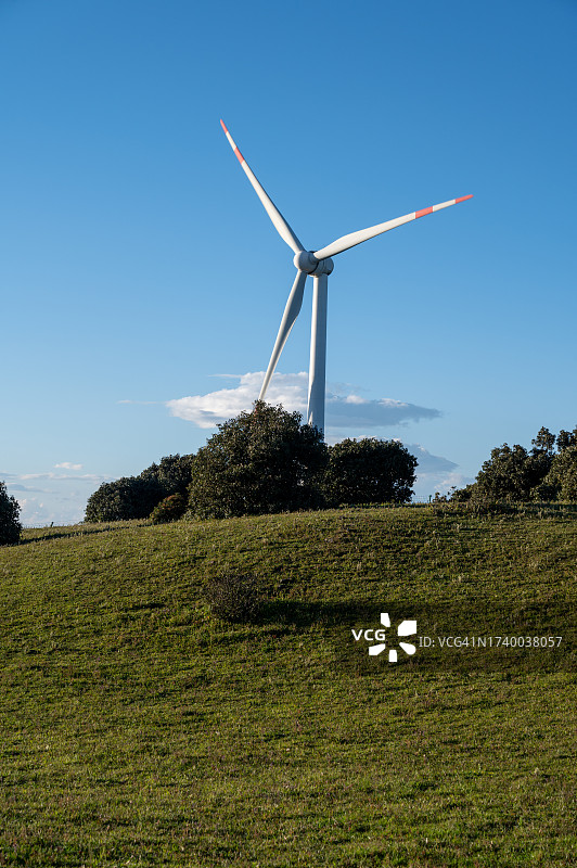 山顶上的旋转风力涡轮机图片素材