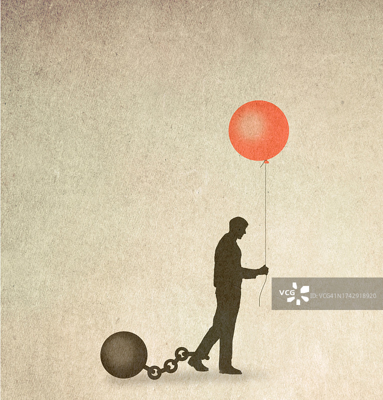 被球和链束缚，手持象征希望的气球的男人轮廓图片素材