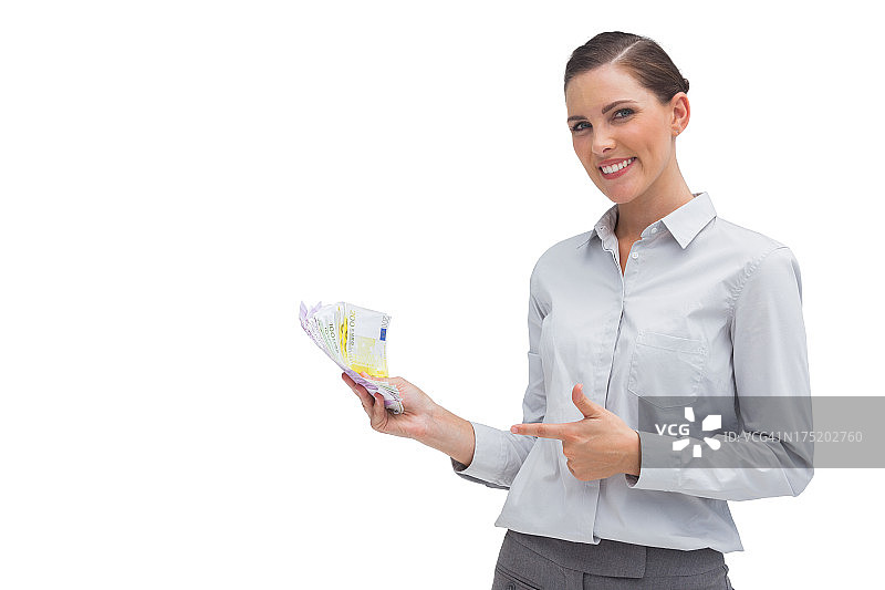 快乐的女商人手持金钱图片素材
