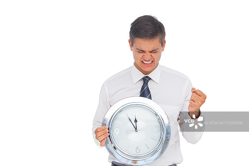 激动的商人拿着时钟图片素材