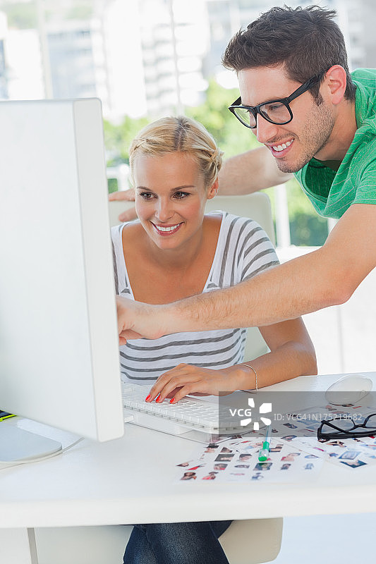 指向电脑的快乐照片编辑师图片素材