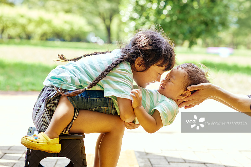 哥哥坐在女孩的腿上拥抱图片素材