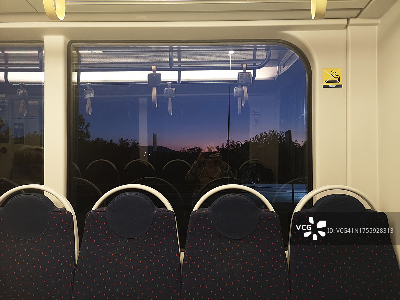 意大利托斯卡纳佛罗伦萨，日出时分，女子拍摄空无一人的地铁的倒影图片素材