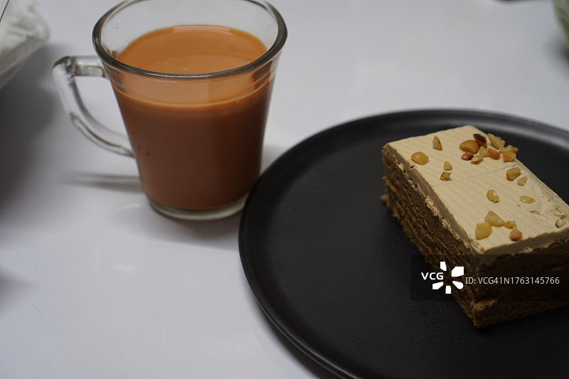 杏仁咖啡蛋糕和玻璃杯中的热茶图片素材