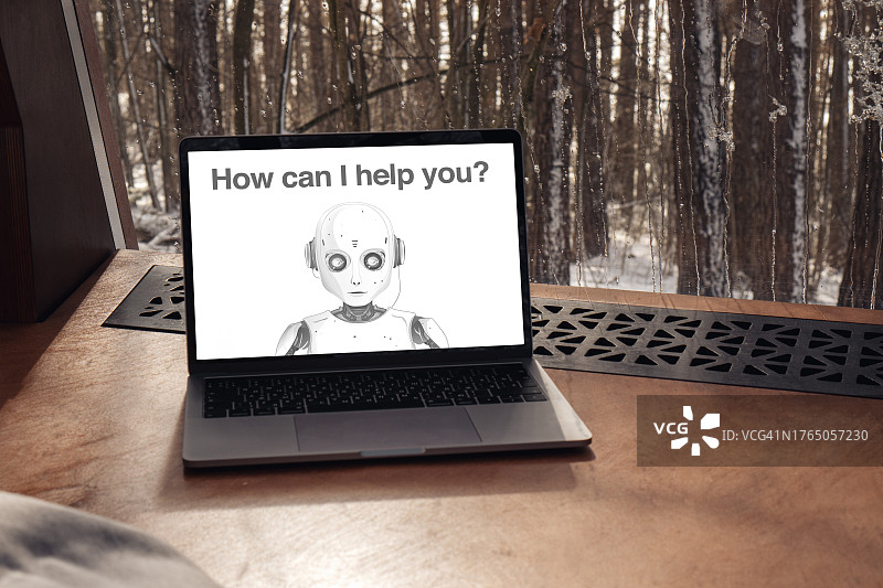 使用笔记本电脑与文本机器人交流。屏幕上的人工智能已准备好提供帮助。未来科技、科学、机器学习概念摄影图片素材