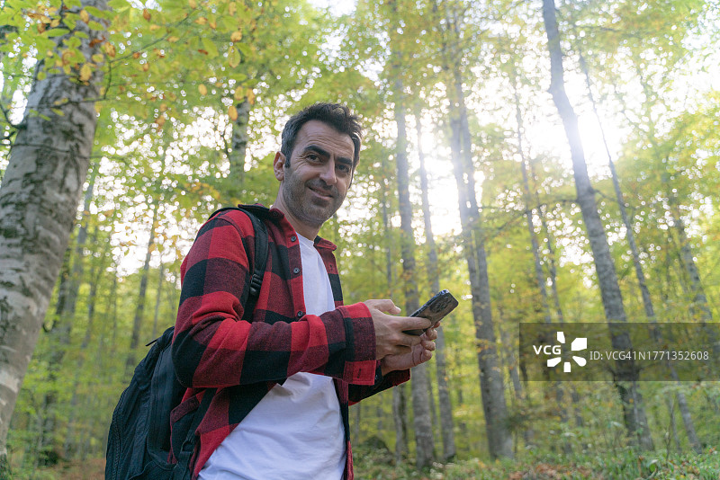 在博卢耶迪格勒国家公园的森林小路上行走，背着背包的男人图片素材