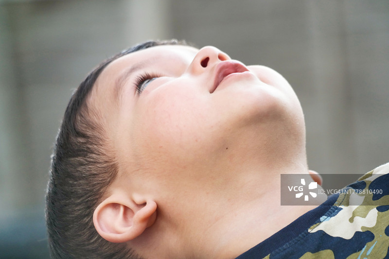 家中花园向上看的可爱的亚洲巴基斯坦男婴特写图片素材