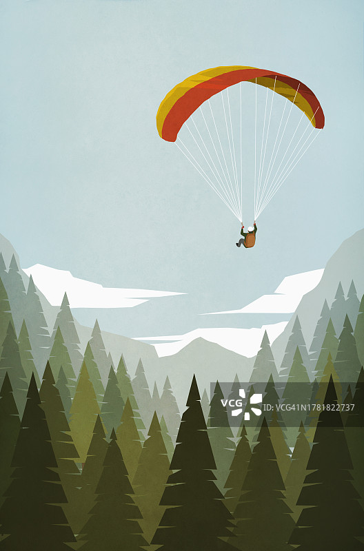 男子在山地森林树顶上玩滑翔伞图片素材