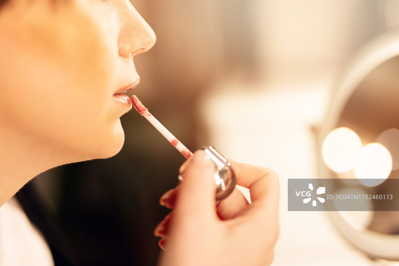 涂着粉色口红的迷人女孩，微笑的化妆女孩图片素材