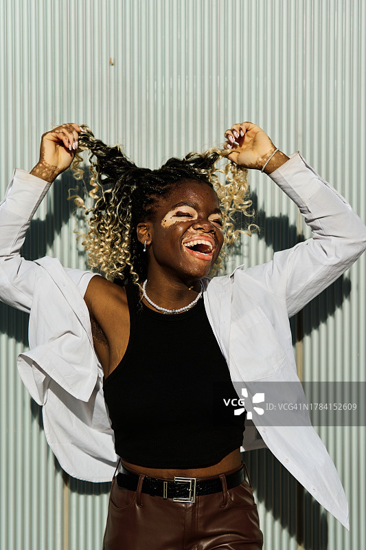 户外玩耍的白癜风女人拿着头发图片素材