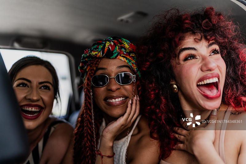 快乐的女性朋友在出租车里看风景图片素材