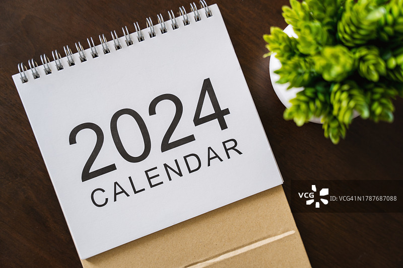 木桌绿植上的2024年日历图片素材