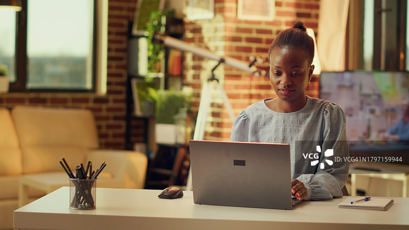 年轻女子在笔记本电脑上工作图片素材