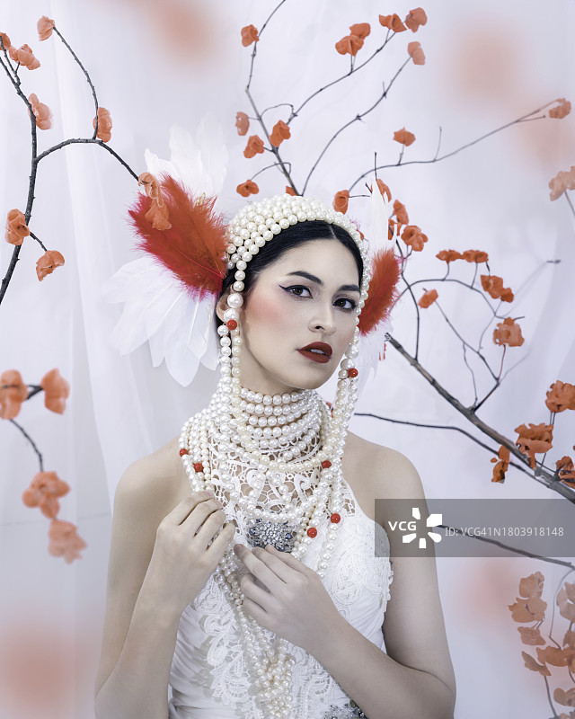 在白色背景上佩戴珍珠项链的女孩肖像图片素材