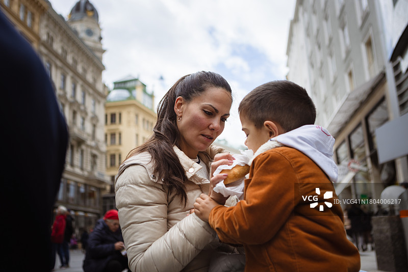 母亲和儿子在维也纳吃美味的传统香肠图片素材