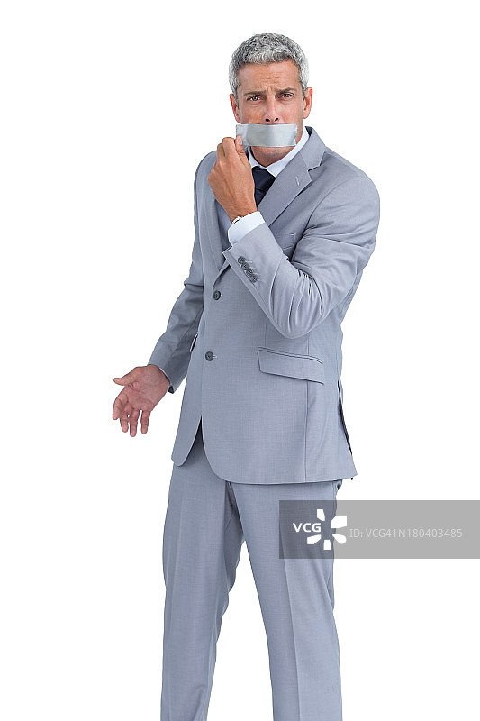 商人撕掉嘴上的胶带图片素材