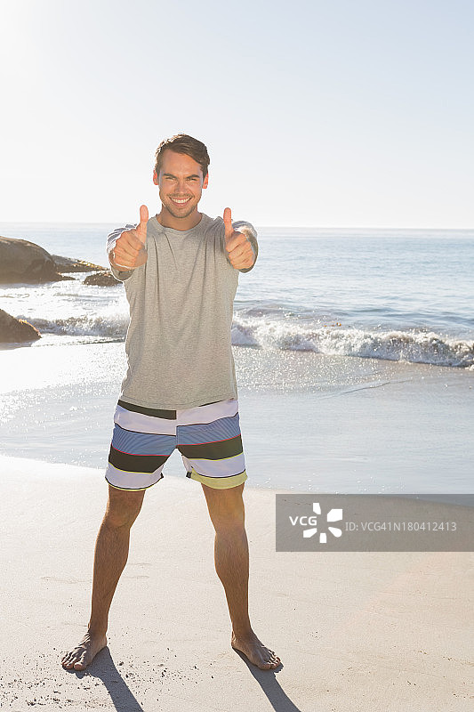 微笑的英俊男人向镜头竖起大拇指图片素材