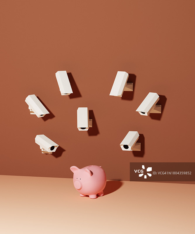 监控摄像头在监视一个存钱罐图片素材