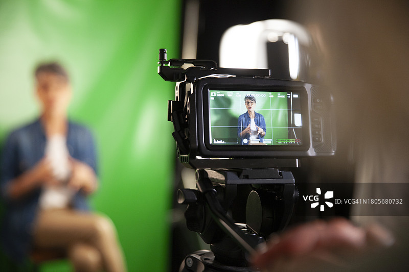 肩部视角：专业摄像机拍摄采访图片素材