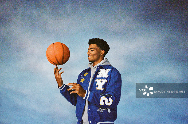 男孩用手指旋转篮球图片素材