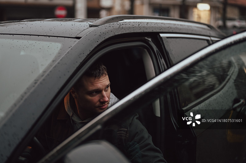 在车里打开车门的严肃中年男人肖像图片素材