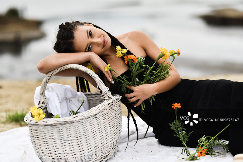 手捧鲜花的华丽女性，眼神充满热情和挑逗图片素材