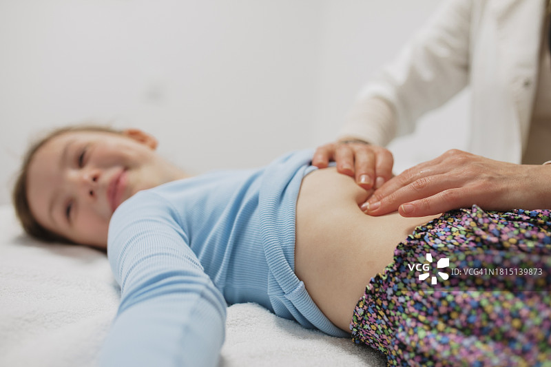 儿科医生为女童检查腹部图片素材