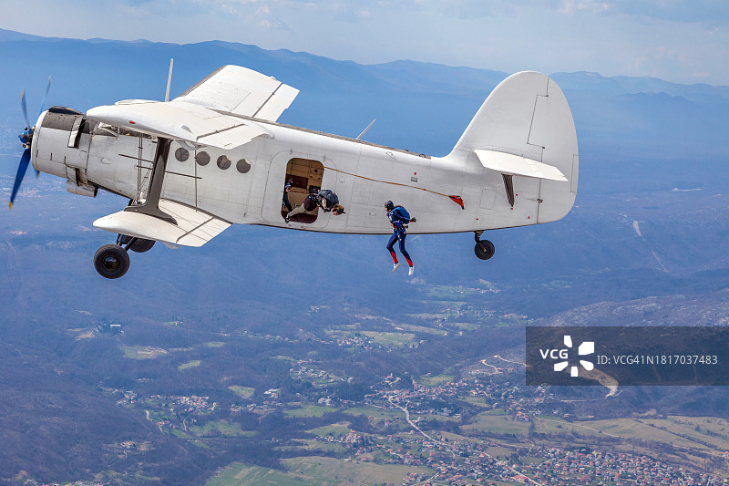 伞兵从老式军用双翼飞机上跳下图片素材