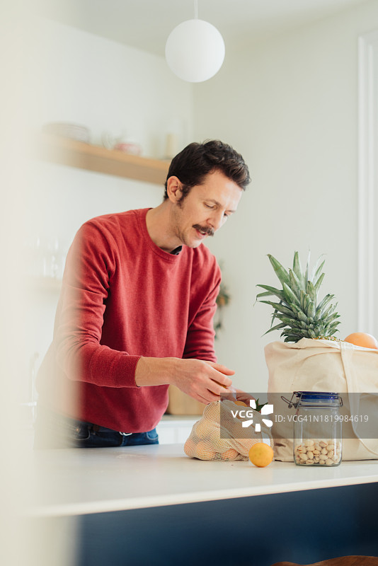 年轻女子手提蔬菜水果购物袋图片素材