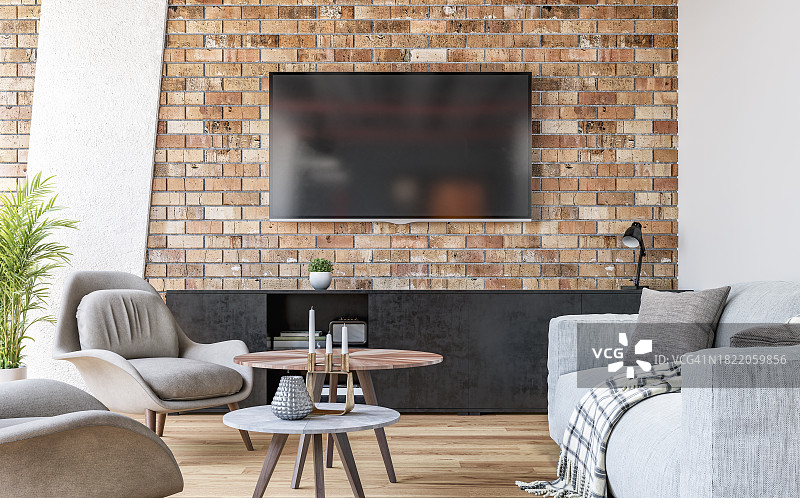 现代客厅，砖墙上装有电视，灰色沙发、椅子和咖啡桌以及装饰品图片素材
