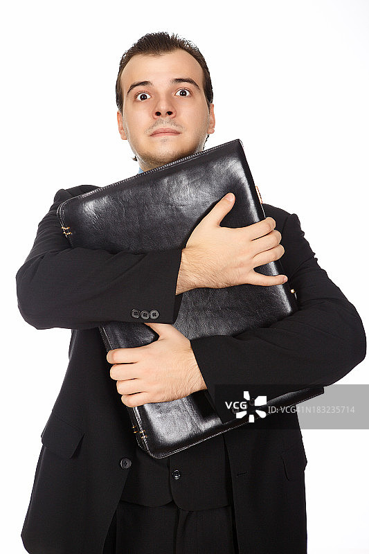 拿着公文包凝视的年轻书生气商人图片素材