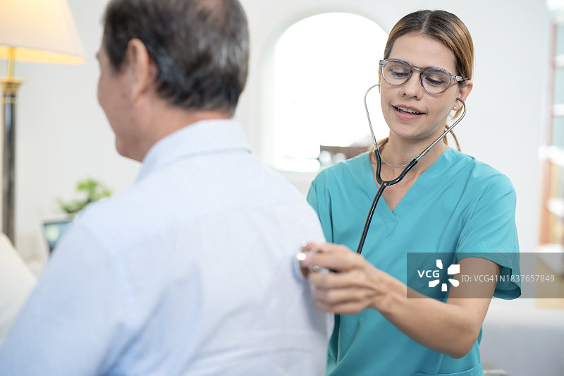 女医生上门用听诊器检查老年人图片素材