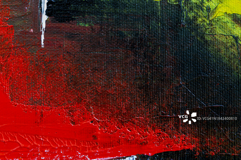 抽象彩色丙烯颜料背景微距特写，红色、黄色和白色在黑色上图片素材