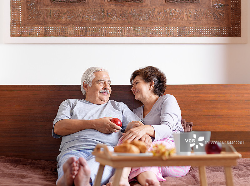 老年夫妇在床上享用早餐图片素材