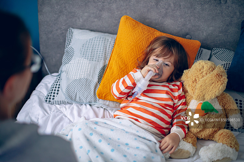 小男孩在家和妈妈一起做雾化图片素材