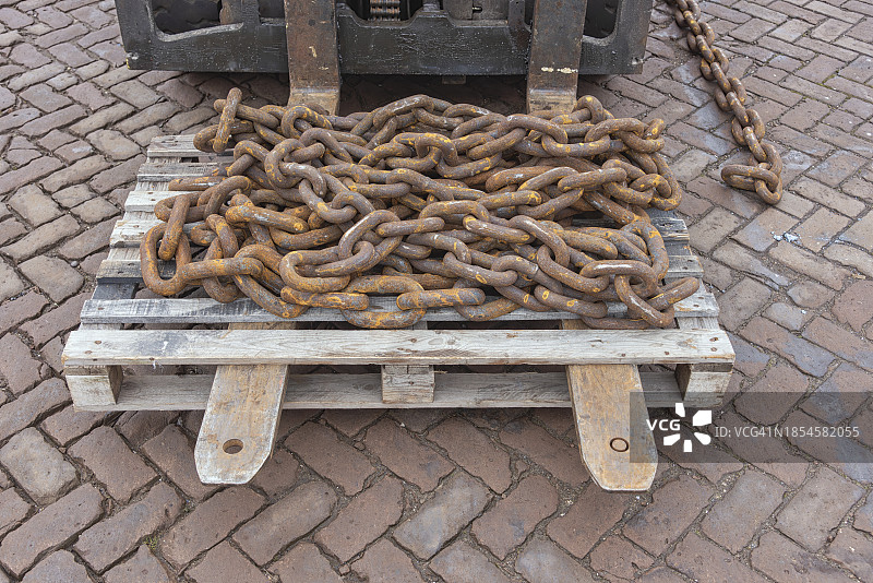 木制工业托盘上的生锈链条图片素材