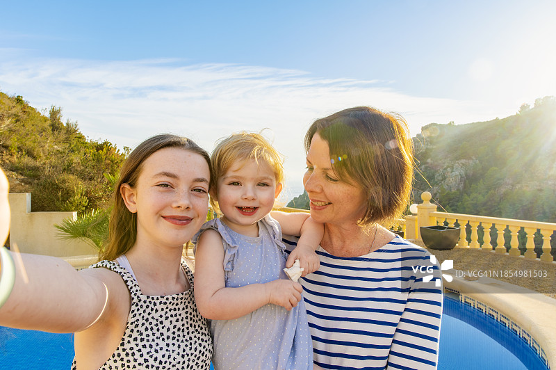 在西班牙白色海岸度假的母亲与两个女儿自拍图片素材